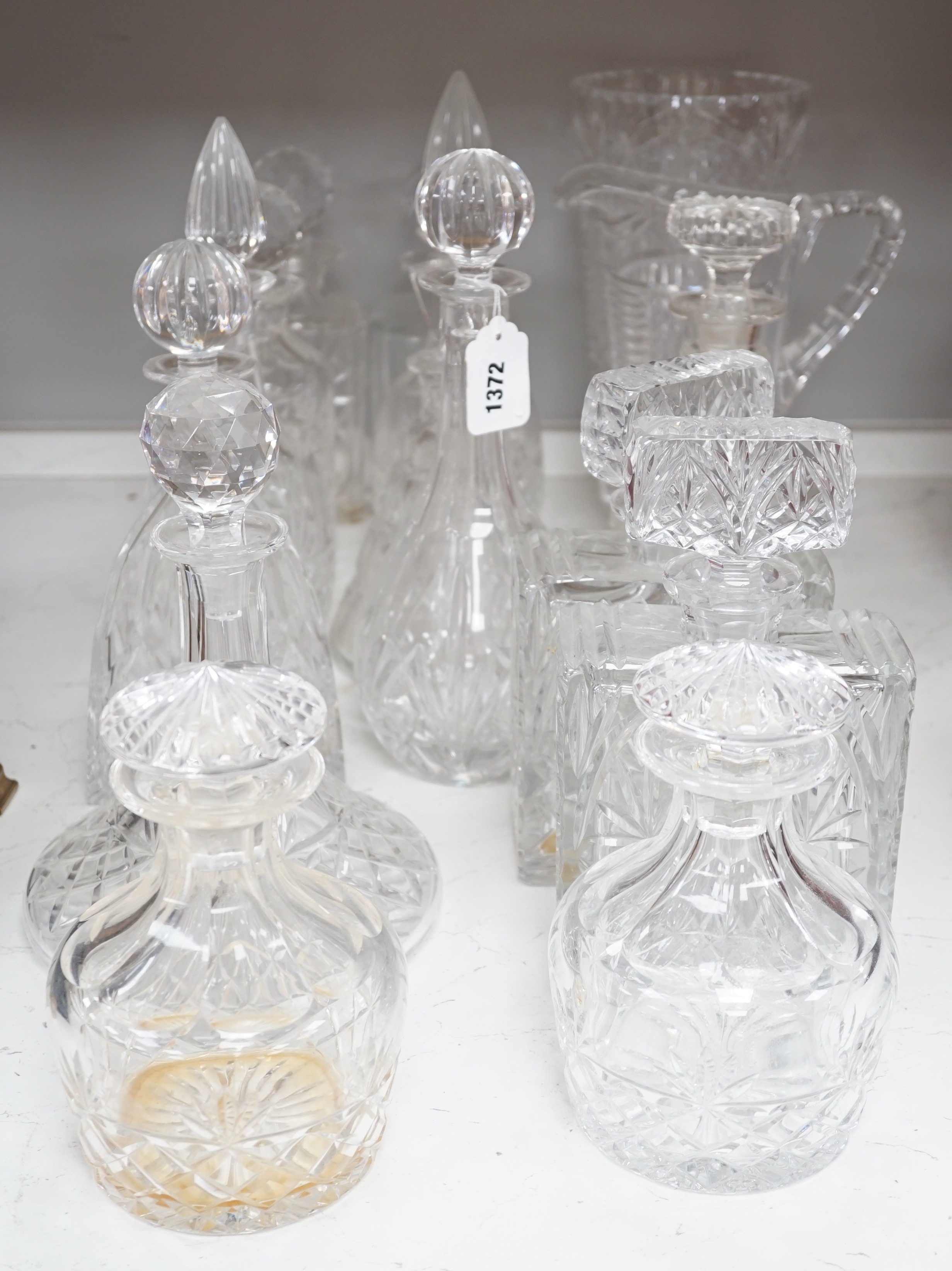 A group of assorted glass decanters and two vases